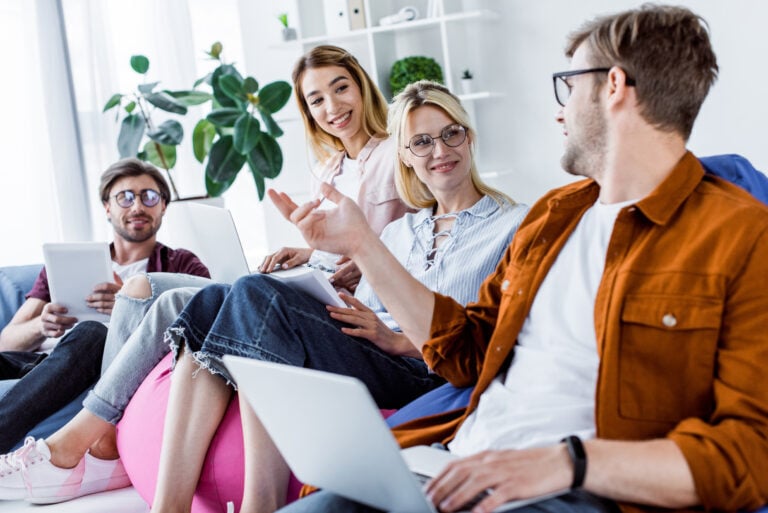 Four colleagues talking to each other at work